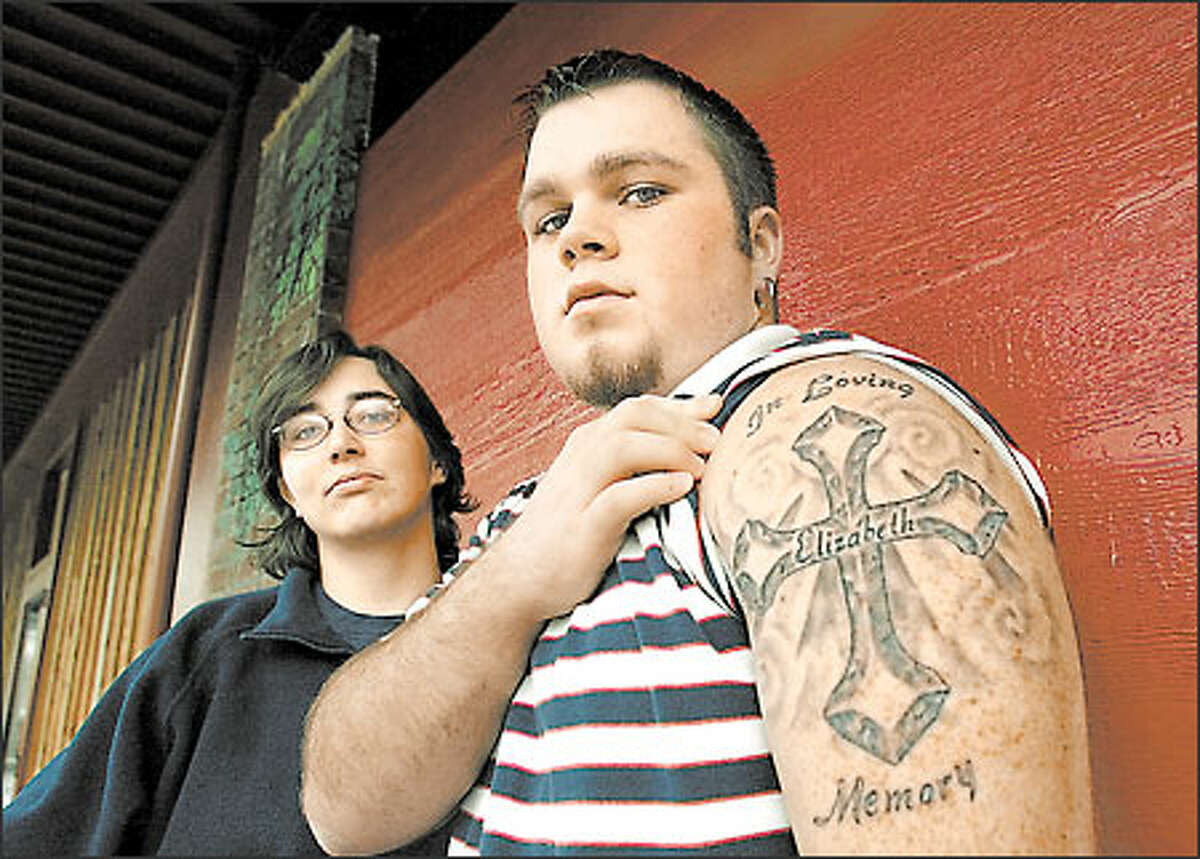 Charles Lamphere, 18, displays a tattoo in memory of his mother, Elizabeth Lamphere, who disappeared in 1996 and was found murdered. When Kent police dodged a missing-person report on Lamphere, the King County Sheriff's Office stepped in and caught her killer. Mary Benton, left, was Lamphere's friend.