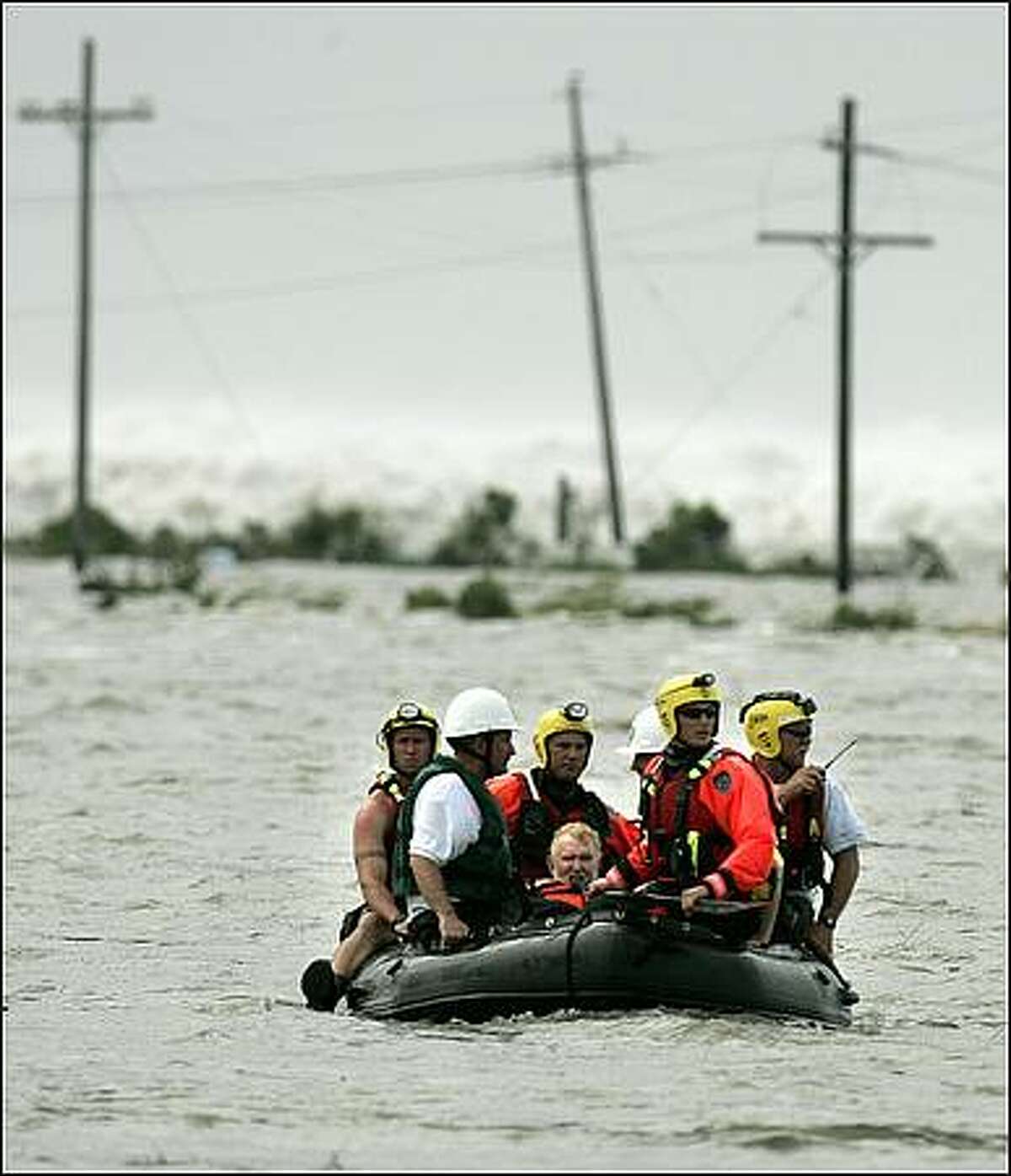 Bill Murphy, center, is taken to high ground by boat after his wife Barbara and two others were rescued by a Coast Guard helicopter in High Island, Texas as Hurricane Ike moves towards Texas. Murphy and his wife were leaving their home in Bolivar and stopped to pick up two stranded motorists when they became stranded too when rapidly rising water hit their truck(AP Photo/The Dallas Morning News, Guy Reynolds)