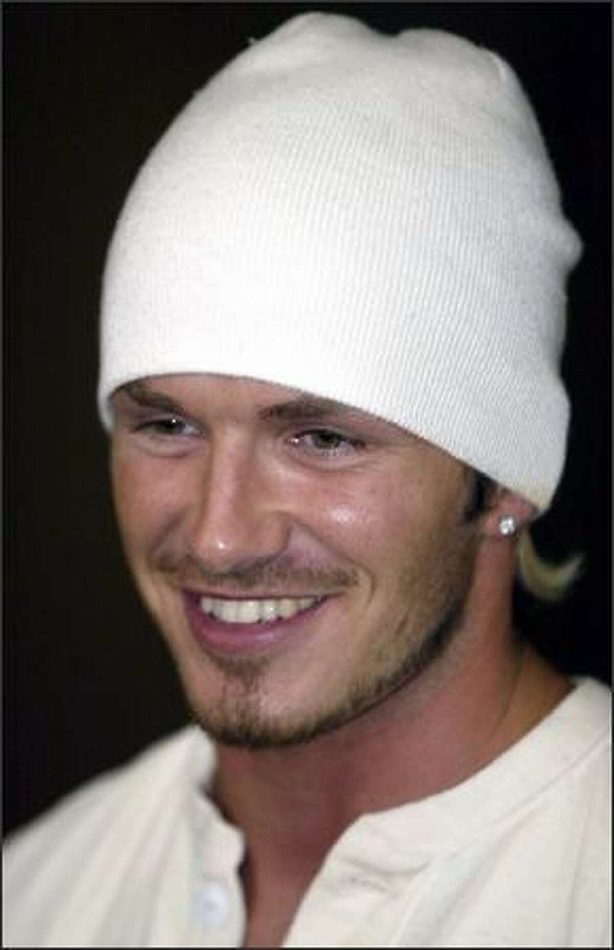 David Beckham greets the media as he announces the birth of his baby boy, Romeo, Sept. 1, 2002 in London.