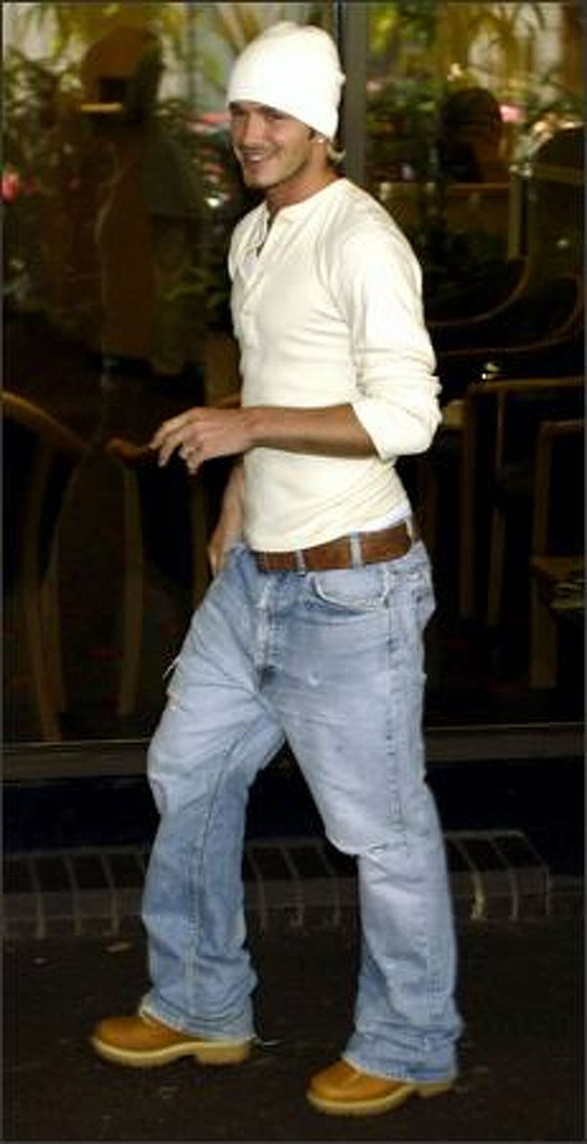 David Beckham walks from the hospital entrance to inform the waiting media of the birth of his baby boy, Romeo, Sept. 1, 2002 in London.