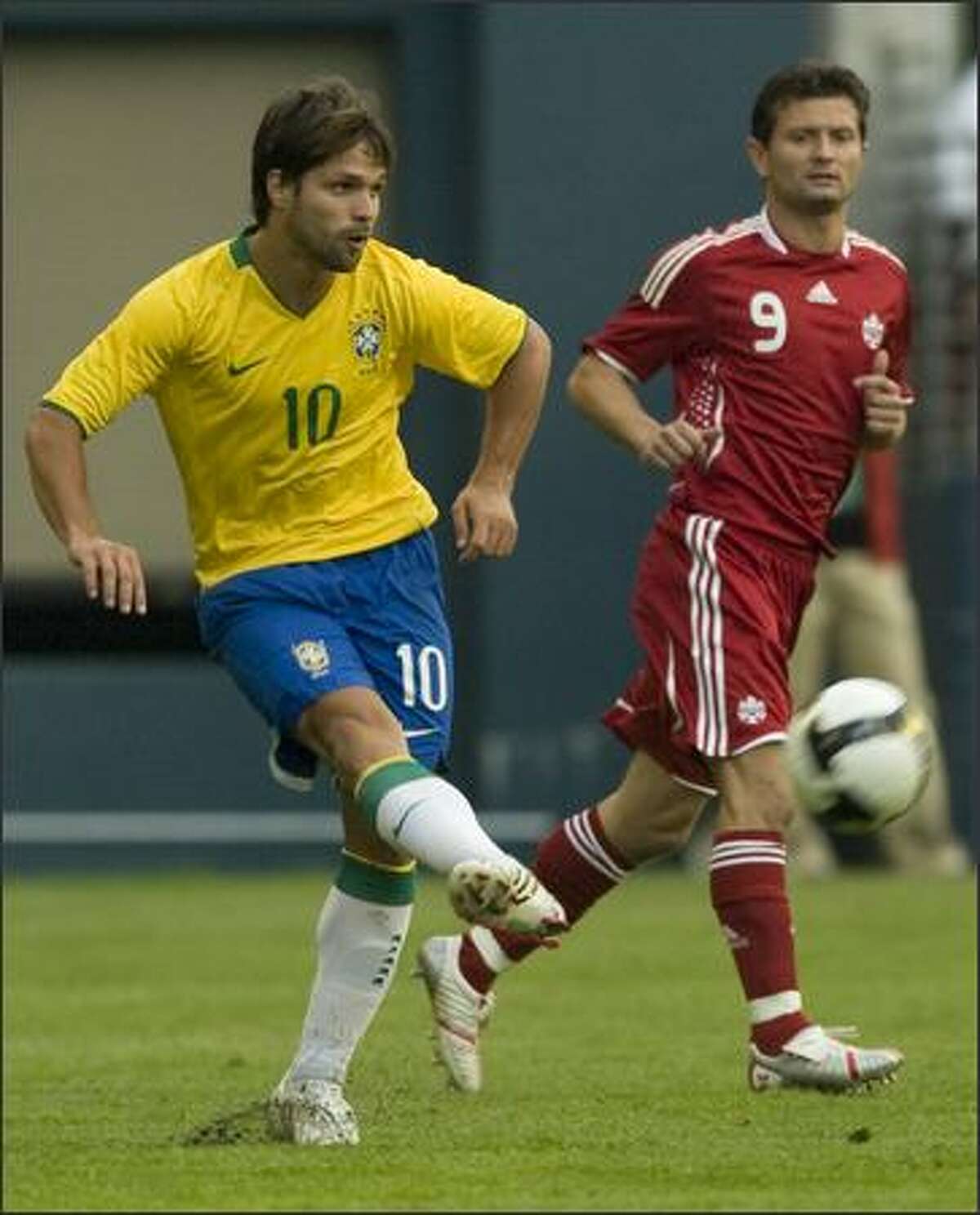 Brazil's Diego (10) fires the ball. Canada's Tomasz Radzinski (9) watches.