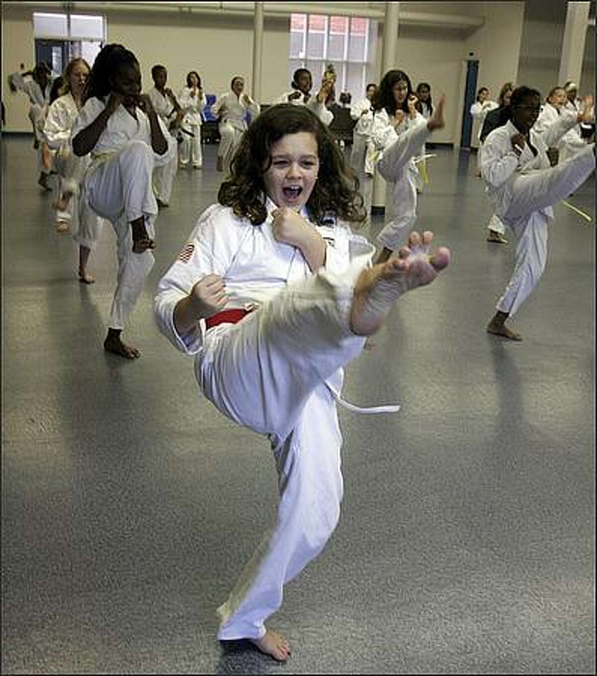 Seventh-grade student Cassandra Gill, who is now a junior black belt, practices with her classmates during gym class at Lake Washington Girls Middle School. Everyone is required to take one term of martial arts per year. Cassandra Gill: