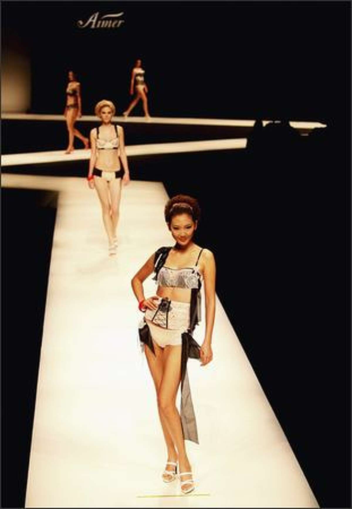 Models pose on the runway during the Aimer Lingerie Trends Release S/S 2009 at the China Fashion Week Spring/Summer Collection 2009 on Tuesday in Beijing, China.