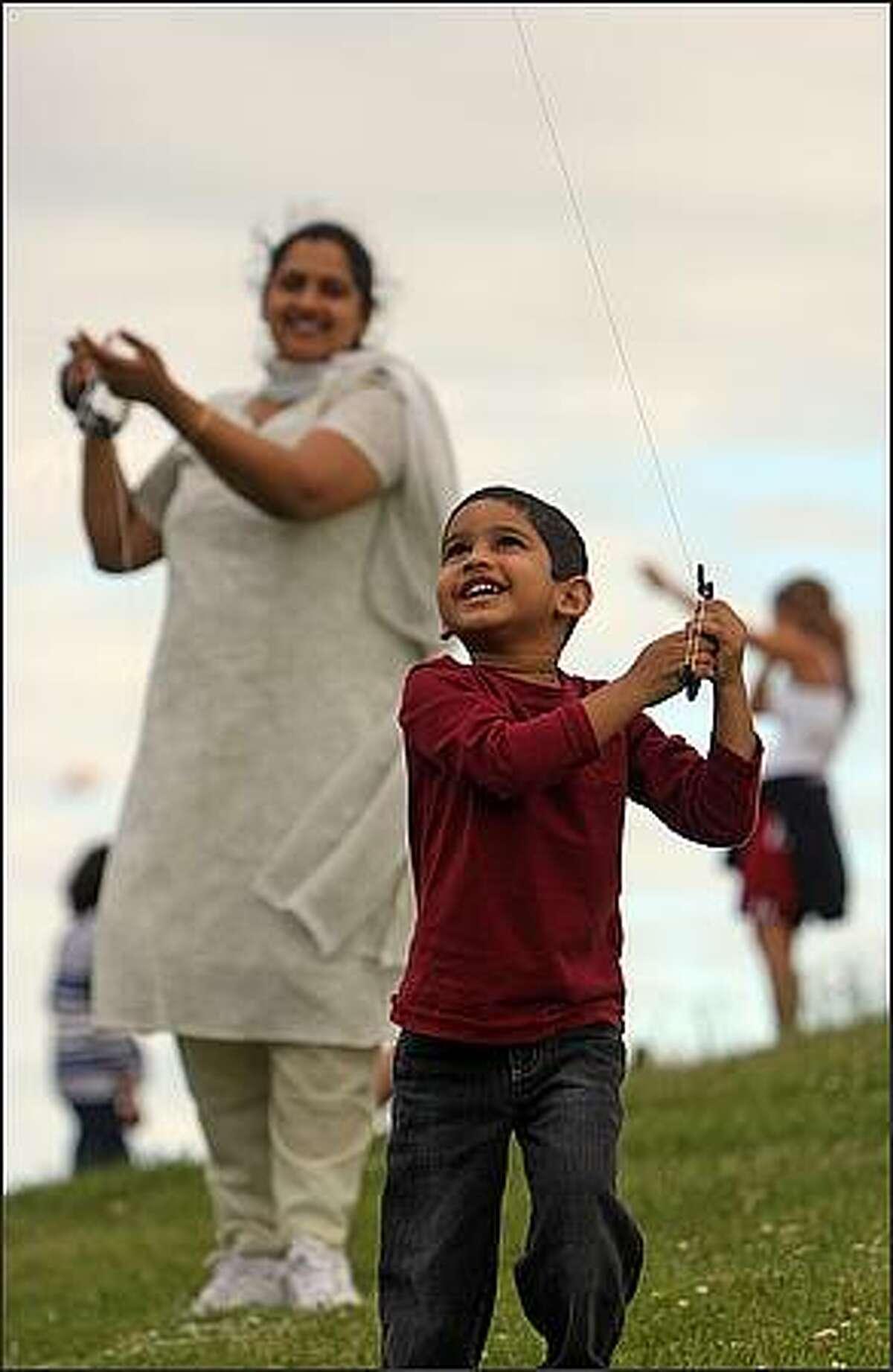 Sanjay Javvadi, 3, of Mercer Island, flies a kite before the fireworks show at Gas Works Park in Seattle on the Fourth of July. He was there with his parents.