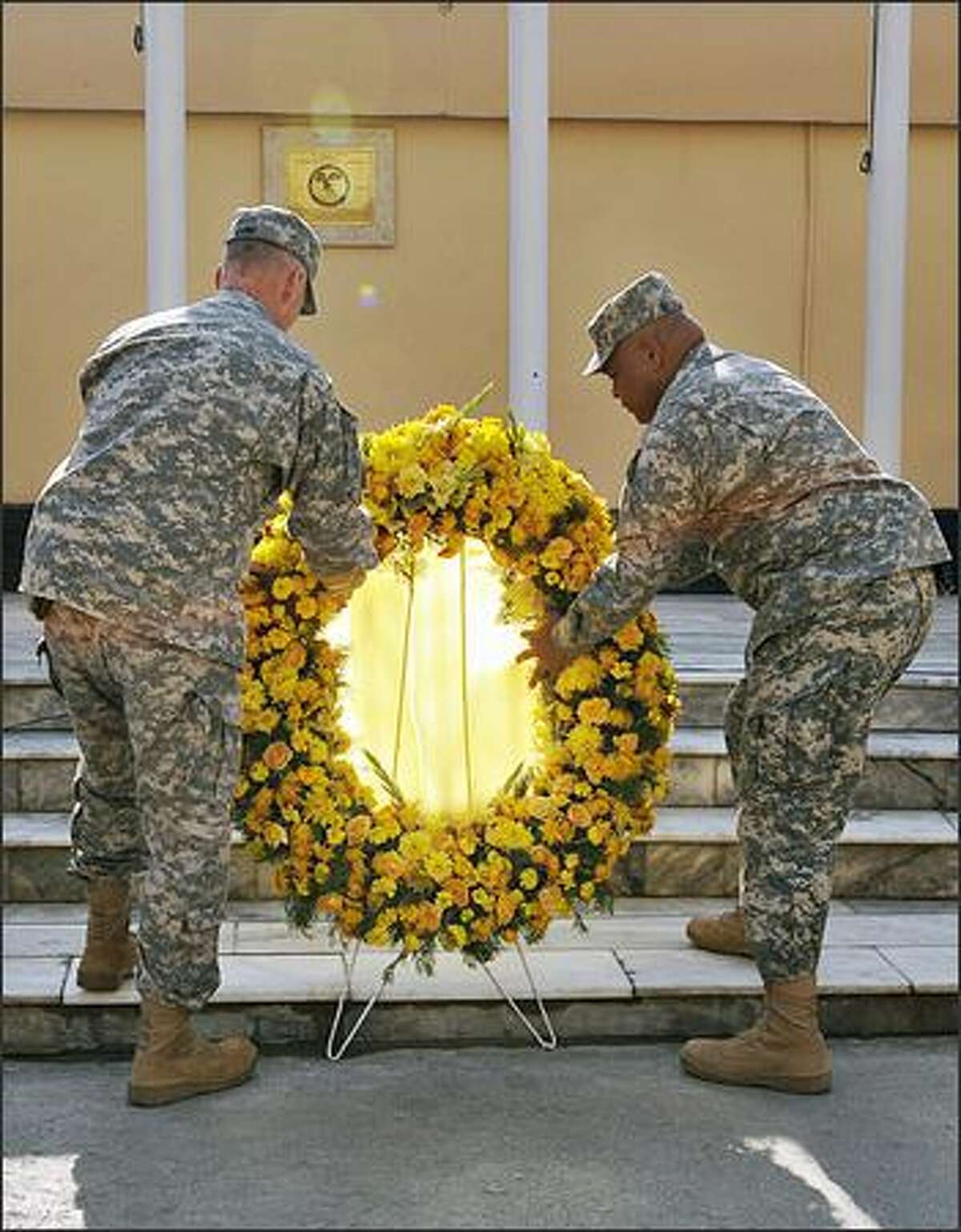 U.S. soldiers lay a wreath during a ceremony for Veterans Day at Camp Eggers in Kabul on Tuesday.