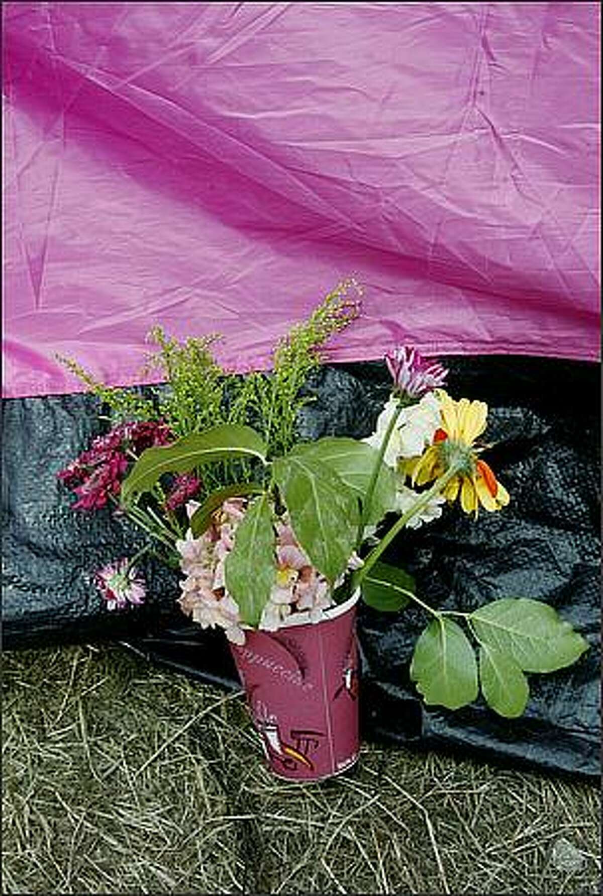 A bouquet of flowers was left propped against one of the pink tents that made up the "Nickelsville" homeless encampment.
