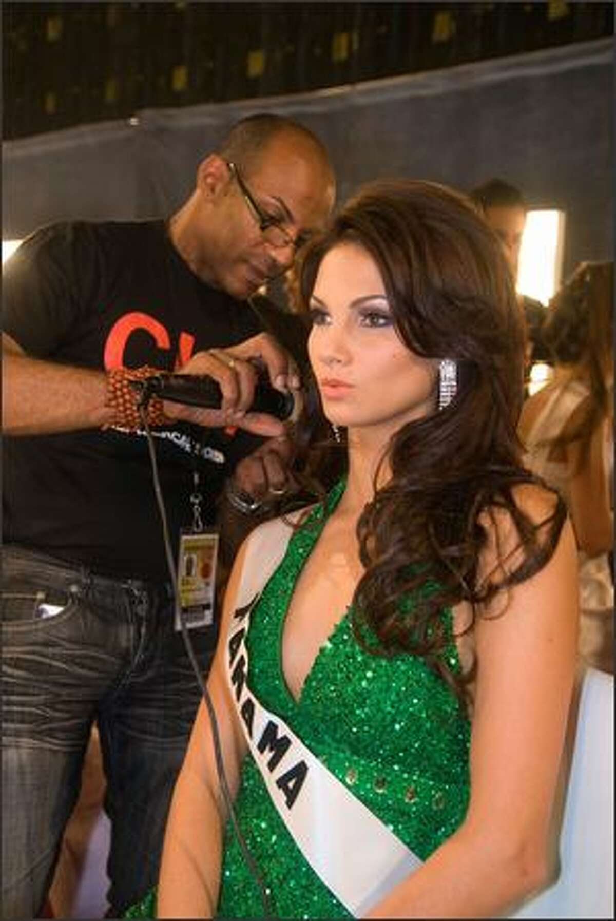 A hair stylist puts finishing touches on Carolina Dementiev Justavino, Miss Panama.