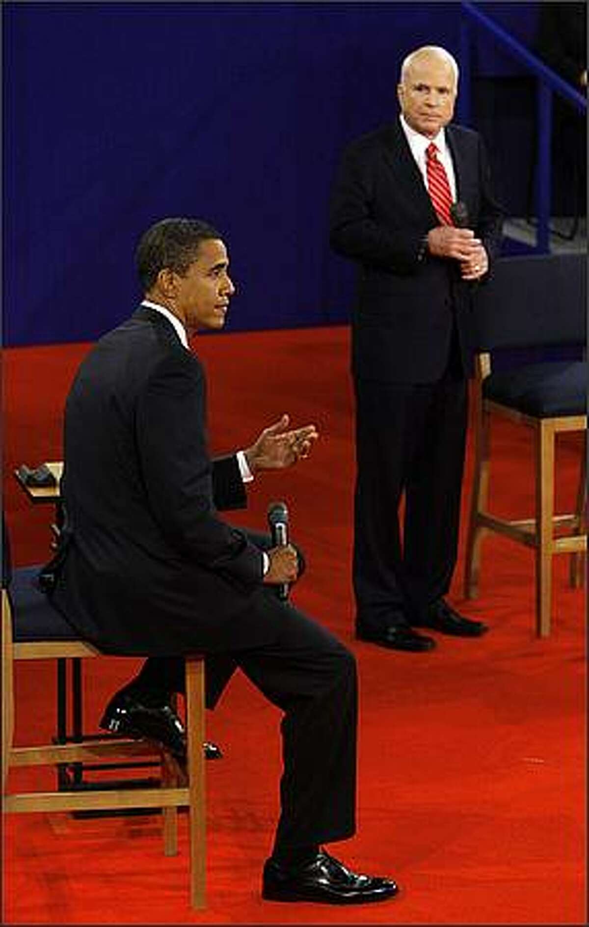 Democratic presidential candidate Sen. Barack Obama, D-Ill., answers a question as Republican presidential candidate Sen. John McCain, R-Ariz., listens at a townhall-style presidential debate at Belmont University in Nashville, Tenn., Tuesday, Oct. 7, 2008. (AP Photo/Charles Dharapak, Pool)
