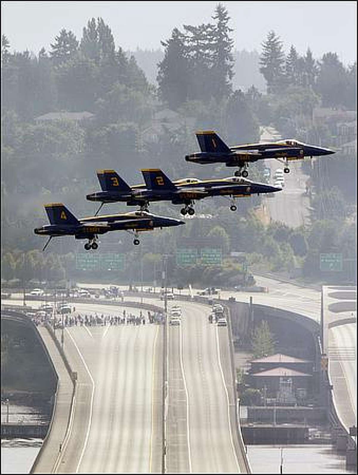 Four of the Blue Angels fly over I-90 during a practice flight over Lake Washington.