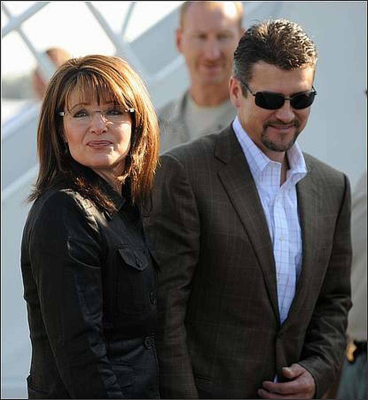 Republican vice-presidential candidate Sarah Palin arrives with and her husband Todd Palin at the Flagstaff, Arizona airport where she is boarding her campaign plane for the trip to St Louis, Missouri. Palin will face-off with her Democratic counterpart Joe Biden in the Vice-Presidential Debate later on October 02, 2008. (ROBYN BECK/AFP/Getty Images)