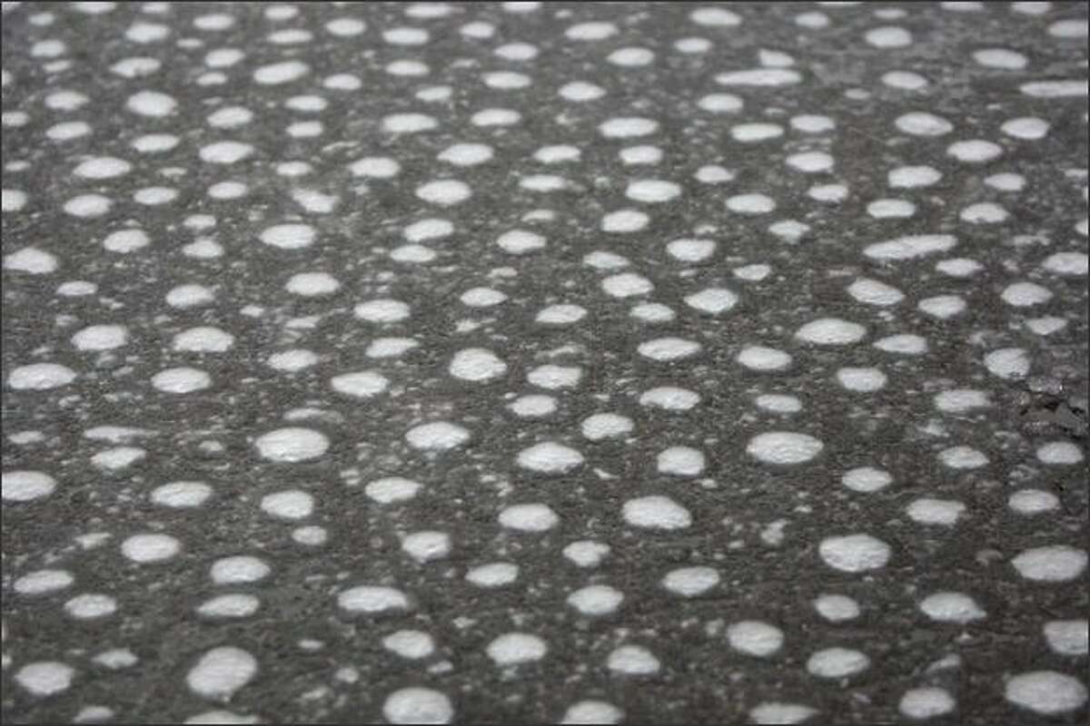 Air trapped beneath slush forms bubbles in the parking lot of Rattlesnake Lake Recreation Area near North Bend on Saturday.