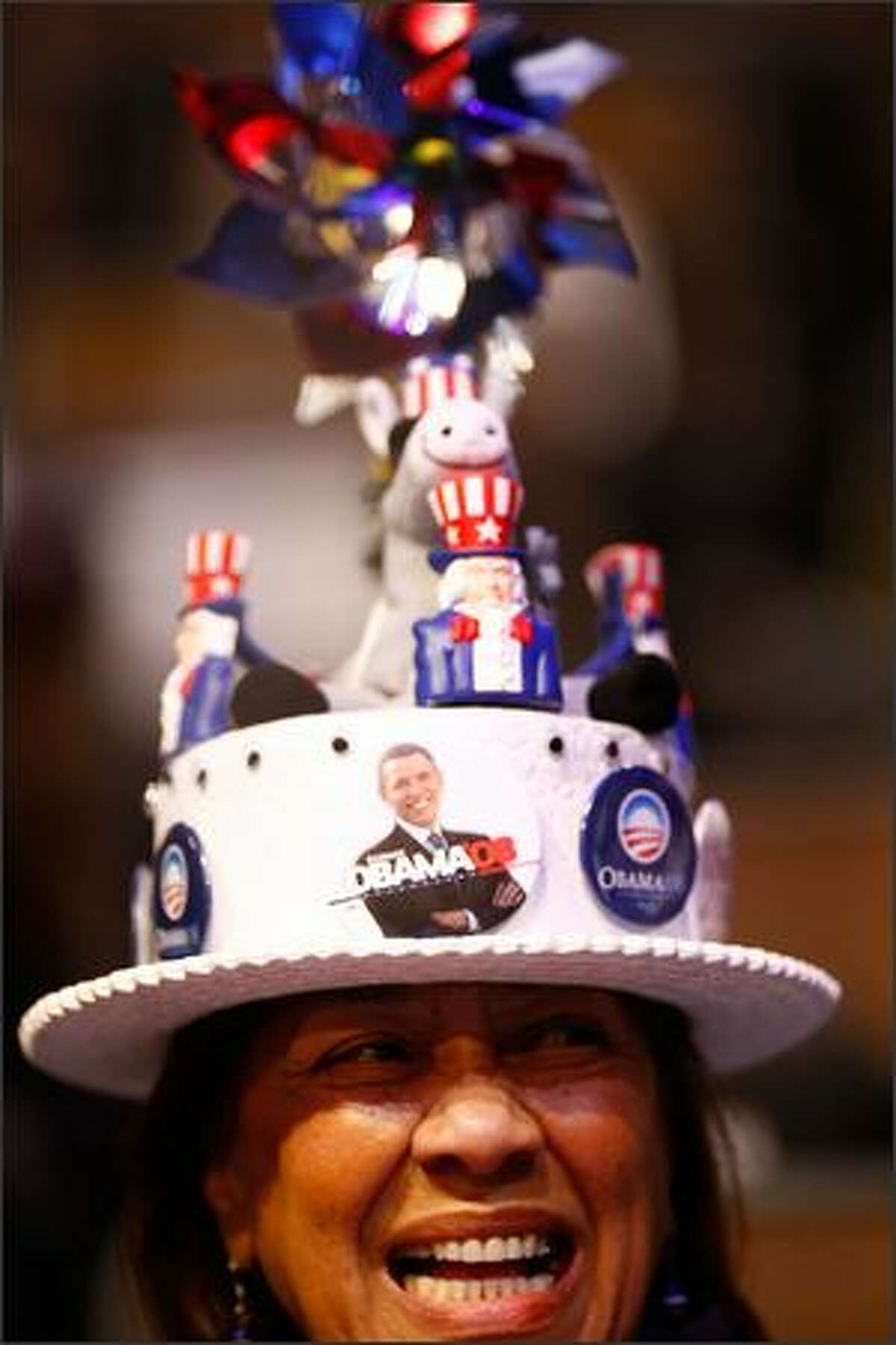 A women smiles while wearing a hat during day one of the Democratic National Convention (DNC) at the Pepsi Center on Monday in Denver, Colorado.