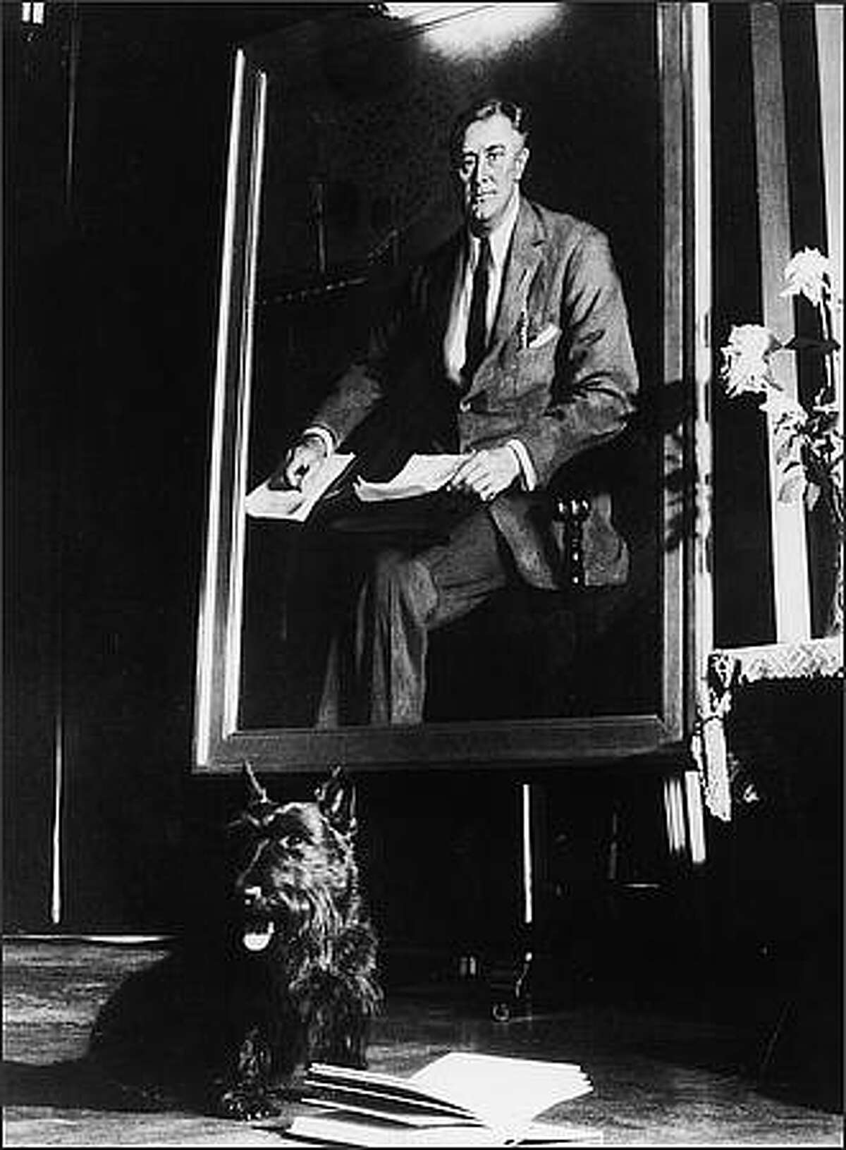President Franklin D. Roosevelt's pet Scottish Terrier Fala sits beside an open book in front of a portrait of the president, 1940s. (Photo by Pictorial Parade/Getty Images)