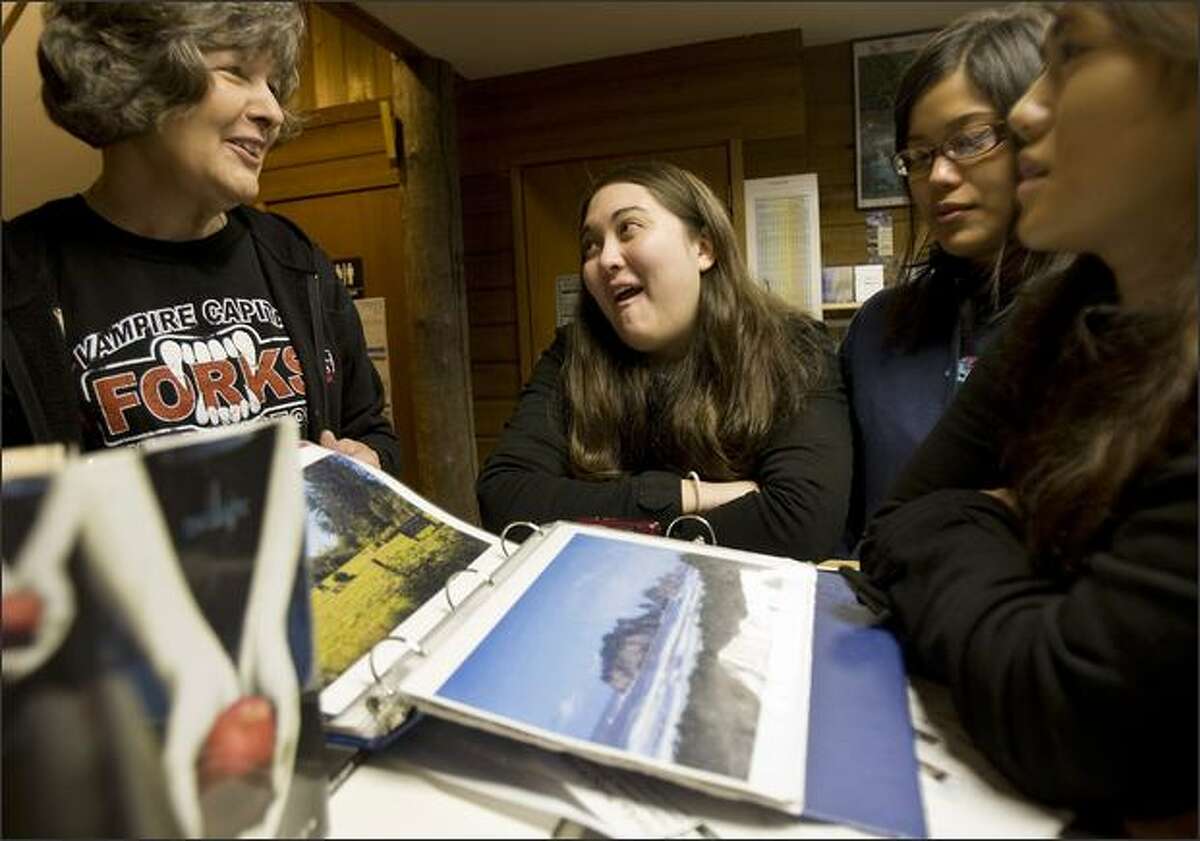 From left, Chamber of Commerce volunteer Marcia Yanish talks with Crystal Bowhall, Masami Araki, and Kelly Fujio before the three head out to find the many different "Twilight" spots on Nov. 7, 2008, in Forks, Washington. The three made a quick day trip over to Forks from Bremerton where they were in town for a friends wedding on Saturday.