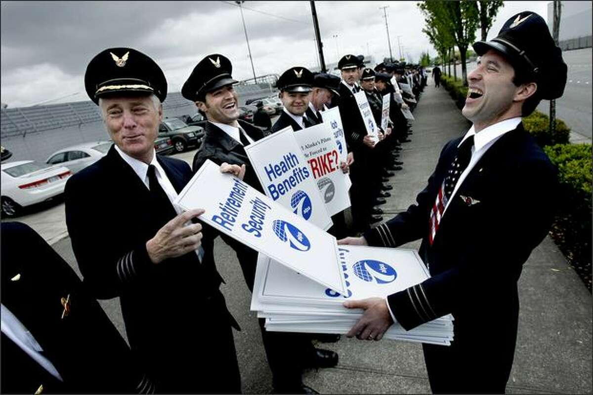 1st Officer Brian Moynihan, right, reacts as Cpt. Claude Tirman jokes about his preference for a sign addressing retirement security during an informational picket of approximately 300 Alaska Airlines pilots outside the Alaska Air Group shareholders meeting at the Museum of Flight.Rogers: There were a huge number of pilots at this picket, and I spent a lot of time trying to show as many of them as possible in my photo. In the end, the personality that shows through in a humorous exchange between these men ended up being far more interesting to me ... and you still get to see a lot of pilots lined up.