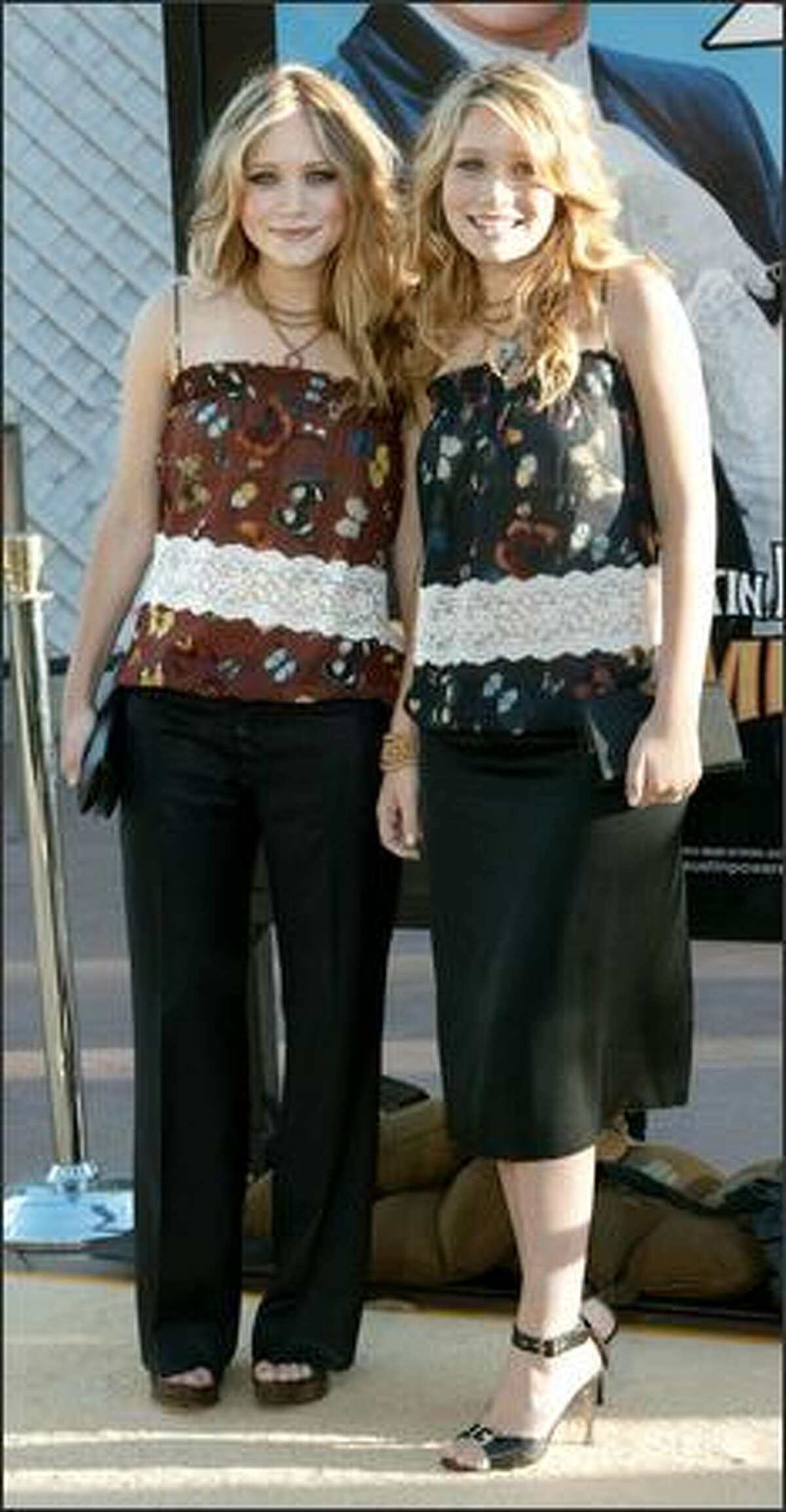 The last vestiges of the twins dressing as one ... Mary-Kate (left) and Ashley attend the premiere of "Austin Powers in Goldmember" in Los Angeles, July 22, 2002.