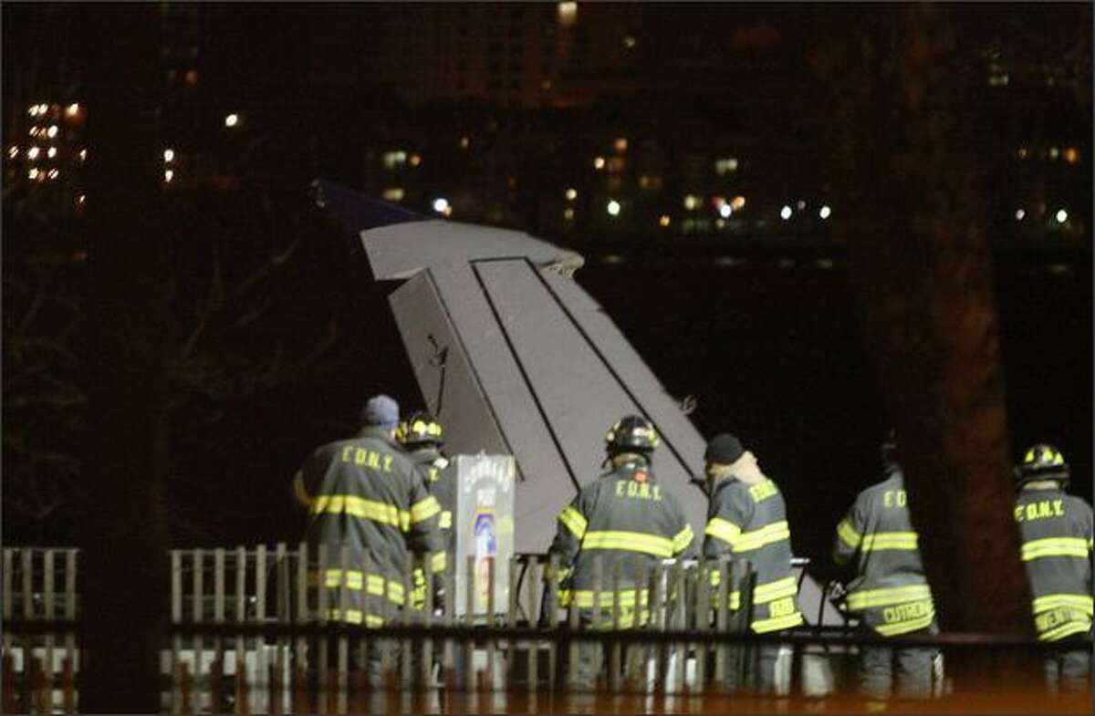 A wing of US Airways flight 1549 sticks out of the Hudson River near Battery Park City, where it was tied after it crashed.