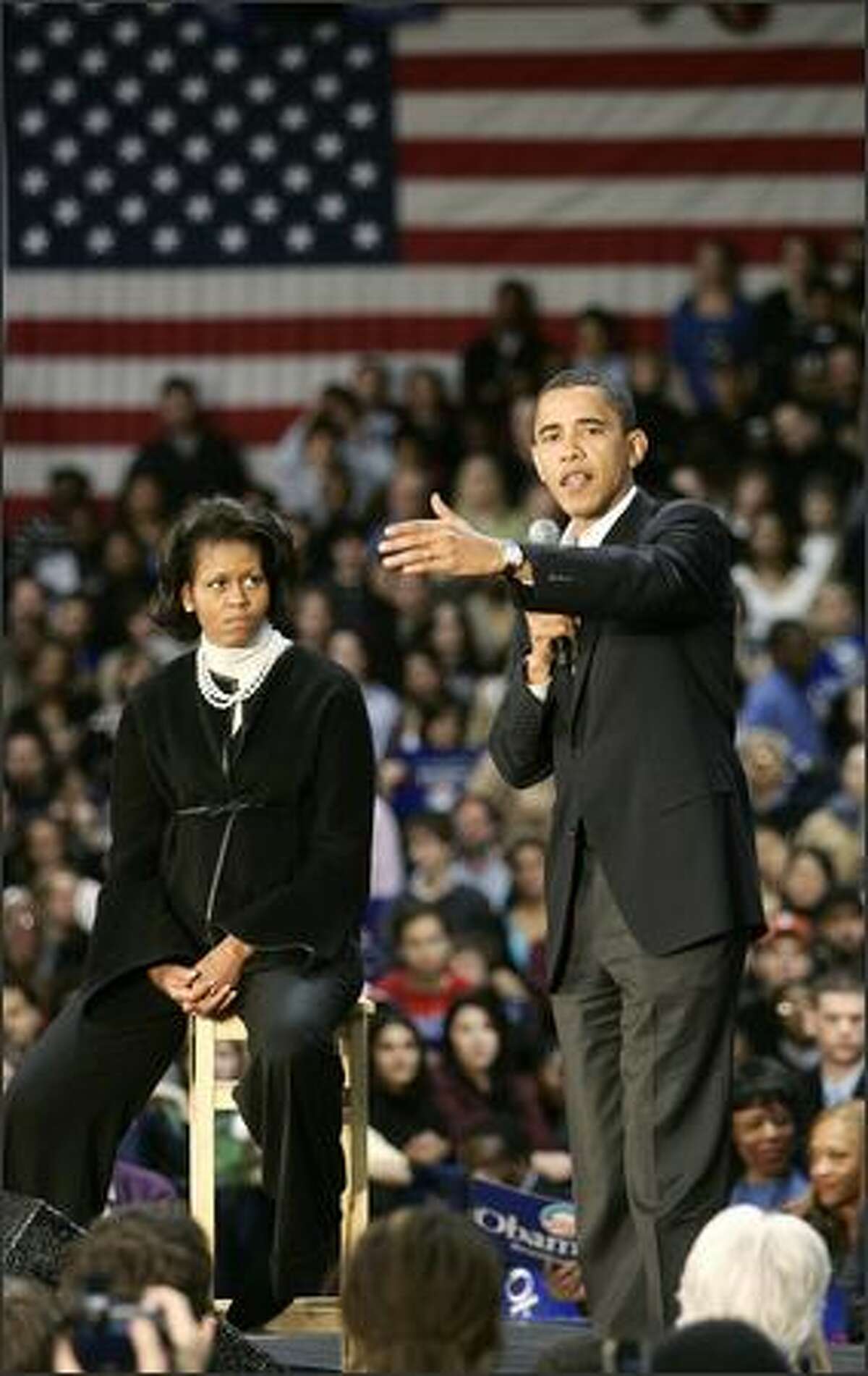 Presidential hopeful Senator Barack Obama, D-IL, speaks during a rally 11 Feb. 2007 at the University of Illinois at Chicago Pavilion in Chicago, as his wife watches.