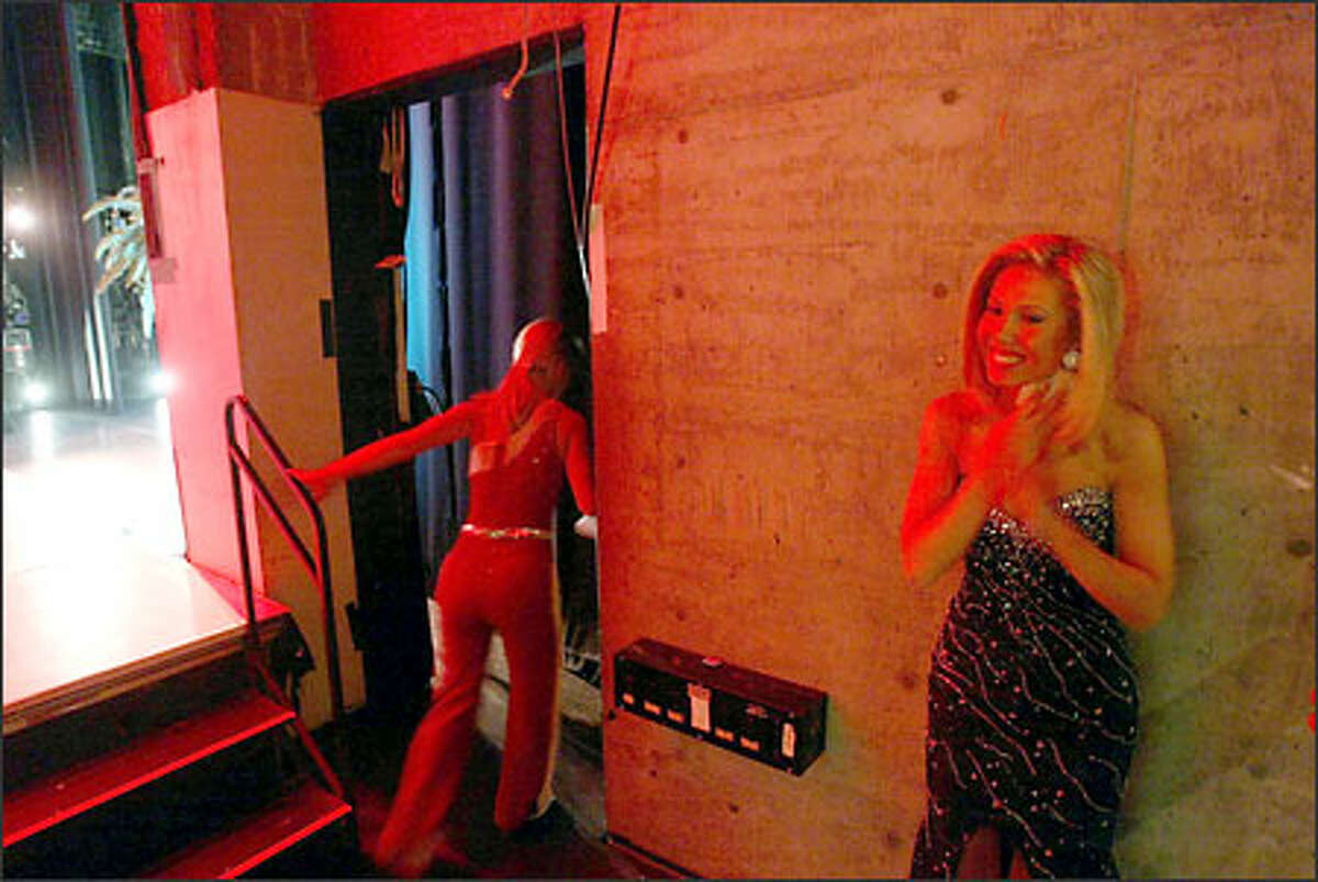 Amy Crawford, right, rubs a cold rag over her neck and chest backstage at the Pantages Theater in Tacoma on Saturday night prior to the talent portion of the show. Crawford became ill and was running a temperature throughout the program. Sbe also vomited several times before the program and also backstage during the program.
