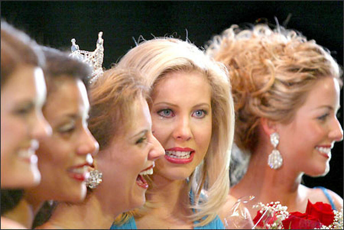 Amy Crawford, second from right, seemed a little dazed as she stood with the four other finalists to have their photograph taken after learning she was first runner-up and will never hold the crown of Miss Washington.