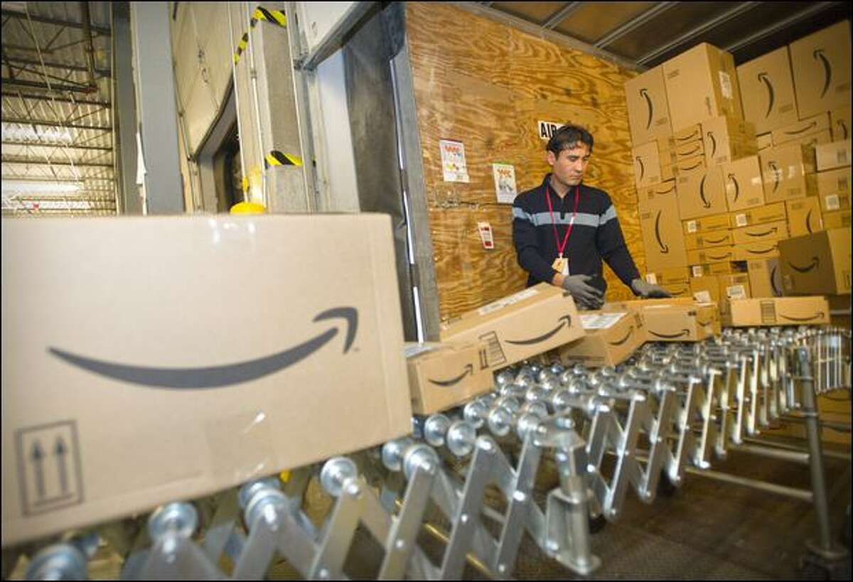 An Amazon.com team member loads boxes of fulfilled orders into a truck at the company's warehouse in Fernley, Nev.