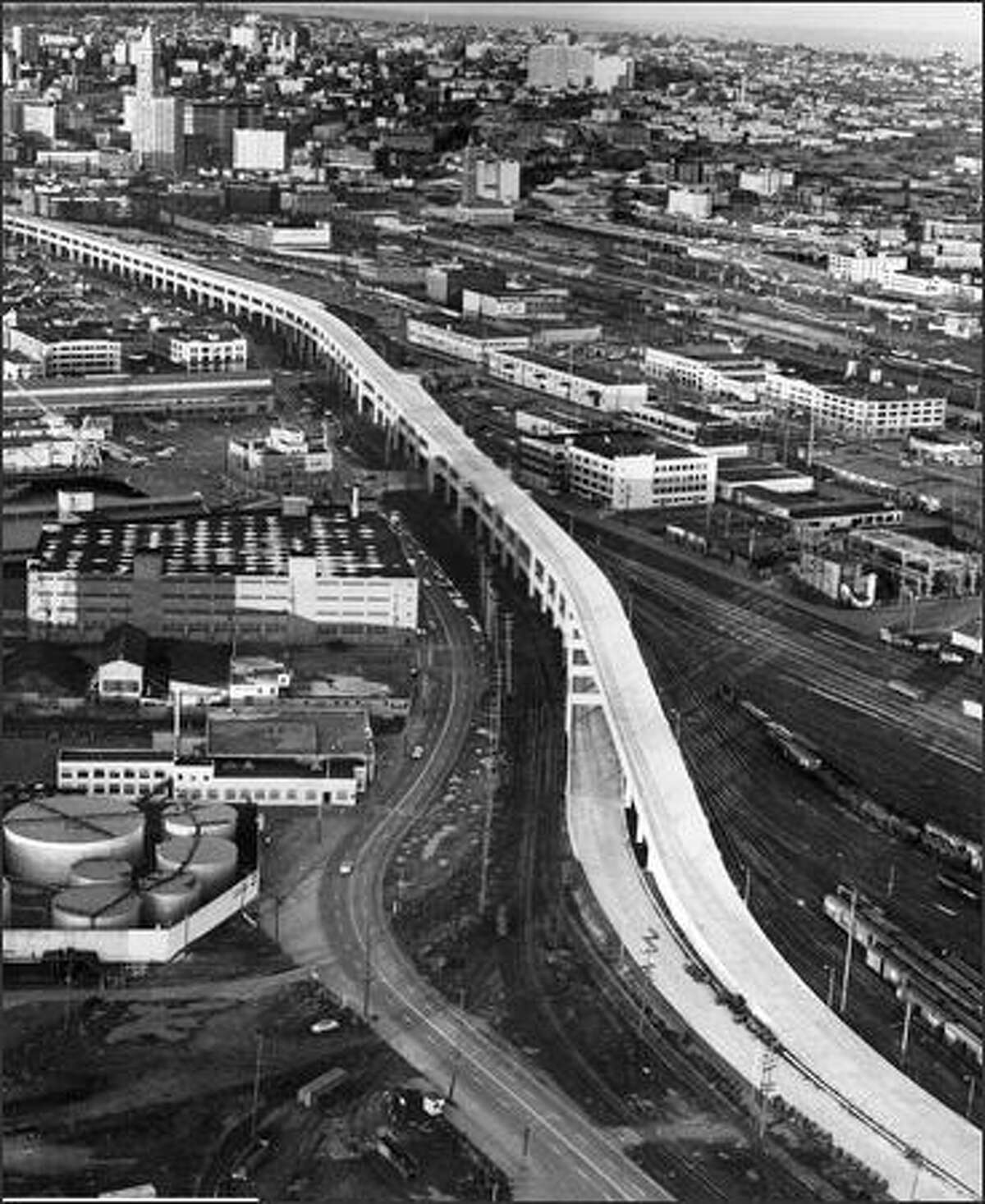 The southern portion of the Alaskan Way Viaduct was completed in late 1958. This photo, taken before cars were allowed on the span, looks northeast, with Smith Tower at upper left. (P-I photo by Phil H. Webber)