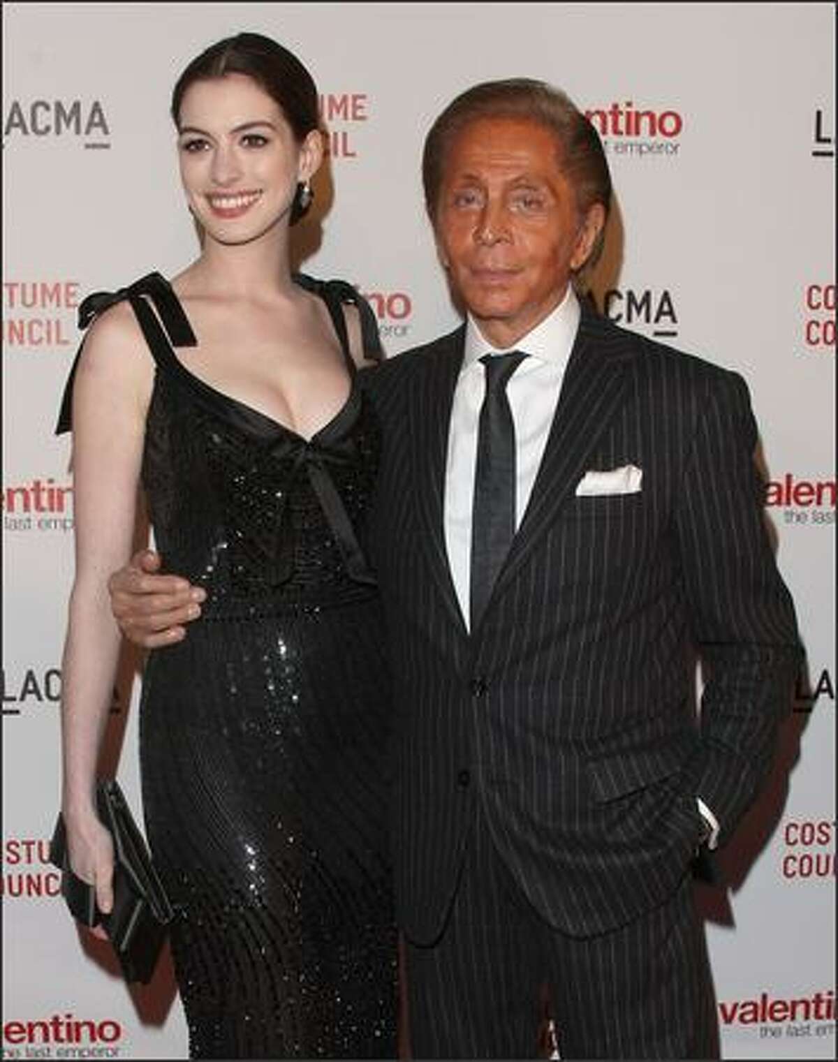 Actress Anne Hathaway and designer Valentino attend the Los Angeles premiere of "Valentino: The Last Emperor" at the Bing Theatre at LACMA in Los Angeles, California.