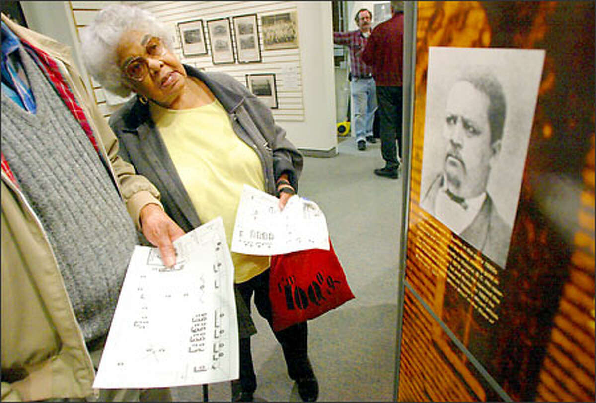 Dolores Bradley, 79, whose grandparents were the first Filipino family to settle in Seattle, looks at the exhibit on the Central District at History House in Fremont.