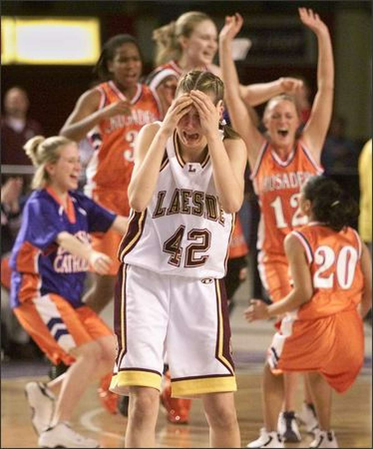 Lakeside's Eleanor Miller walks away in tears as Eastside Catholic celebrates their 49-43 victory in their semi-final game at the Tacoma Dome on March 1, 2002. (Photo by Mike Urban/Seattle Post-Intelligencer)