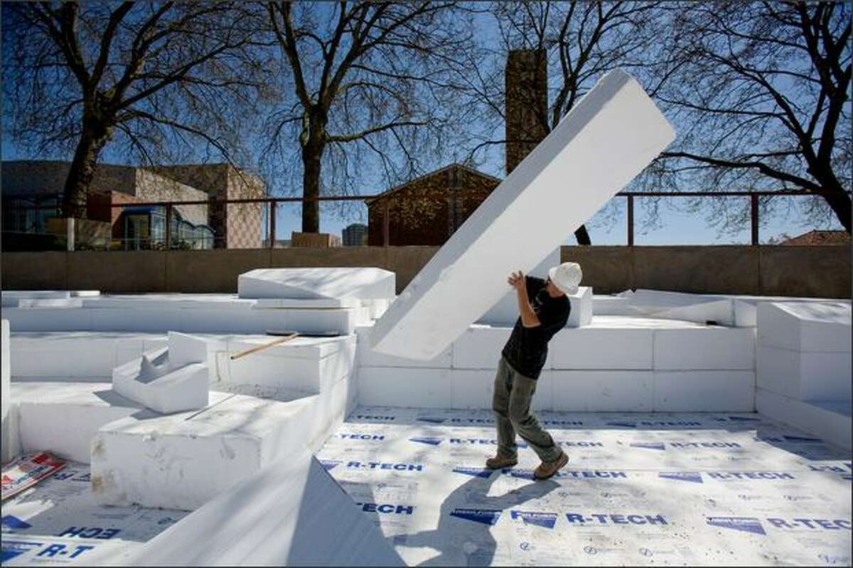 Joe Chopek works April 24 on a large puzzle of plastic foam that will become part the new Seattle Center Skate Park in Seattle.