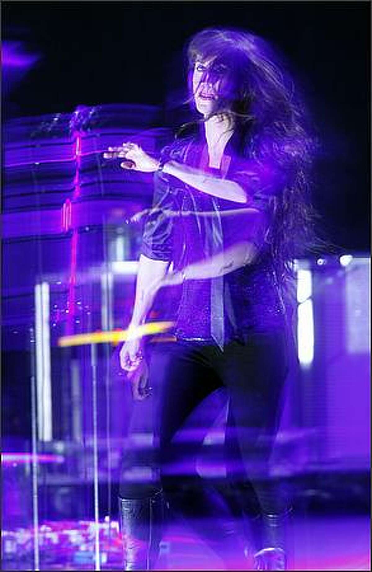 Illuminated by strobe lights and captured by a slow shutter speed Alanis Morissette plays the Paramount Theater.