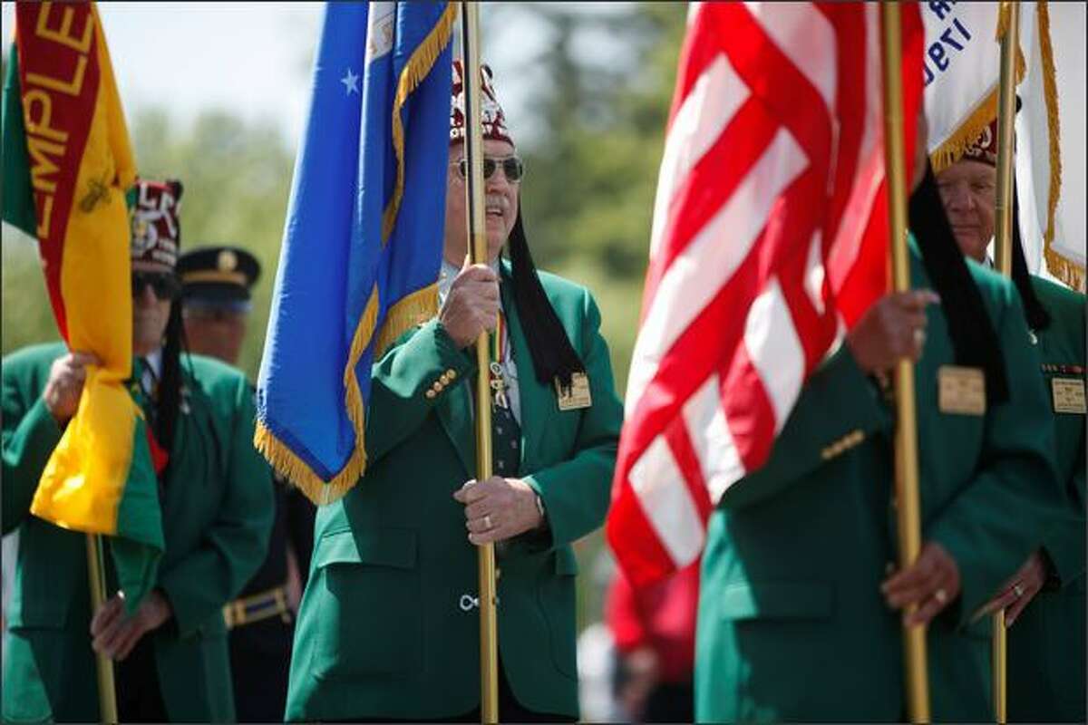 The Nile Temple Legion of Honor Unit from Mountlake Terrace carries out a Presentation of the Colors during the Memorial Day celebration Monday at Tahoma National Cemetery in Kent.