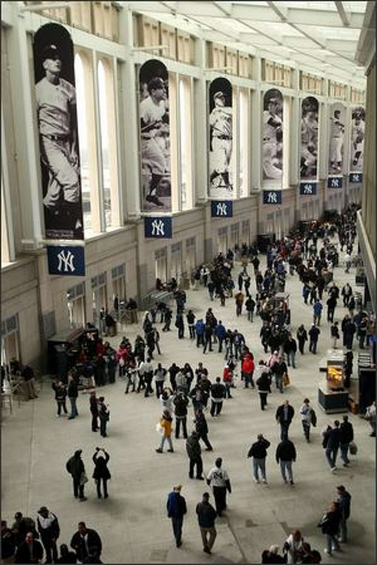 Spectators walk through the Great Hall of the new Yankee Stadium before the New York Yankees' exhibition game against the Chicago Cubs on Friday in the Bronx borough of New York. The game marked the first time the Yankees played in their new ballpark.