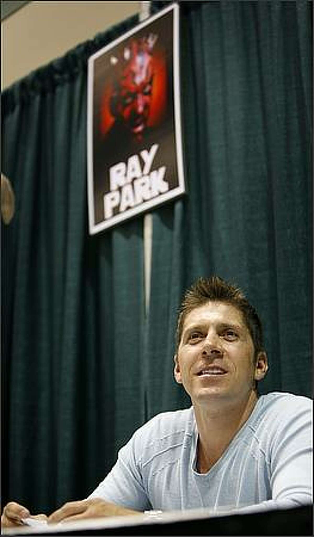 Ray Park, the actor who played Darth Maul in Star Wars: Episode I - The Phantom Menace, signs autographs for fans at the Emerald City ComiCon.