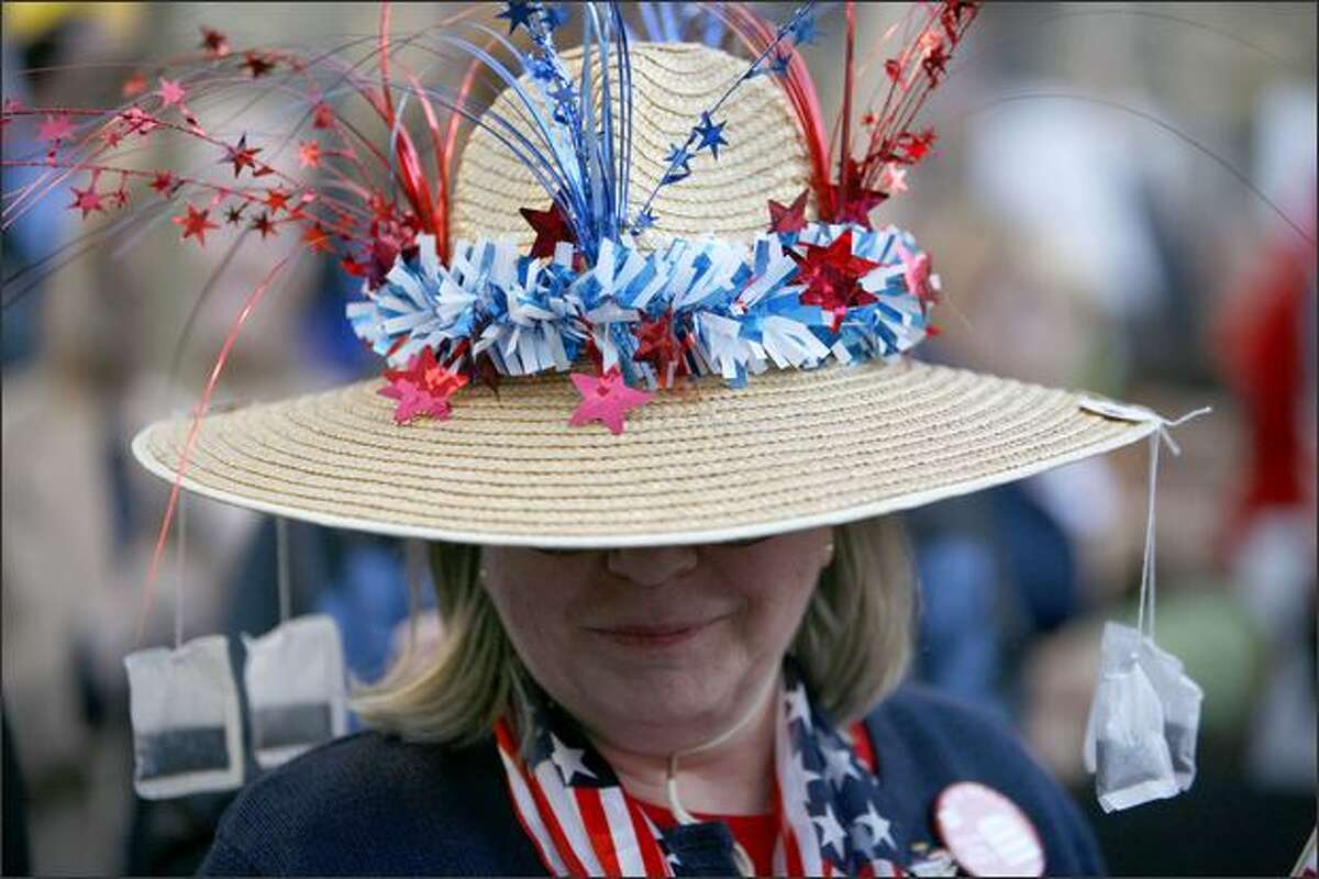 A protester wears a hat adorned with tea bags during a Tax Day "Tea Party" government spending protest on Wednesday, April 15, 2009, at Westlake Park in Seattle. Similar gatherings were held around the country with thousands gathering at the state capitol in Olympia to show their dislike of government spending and taxing.