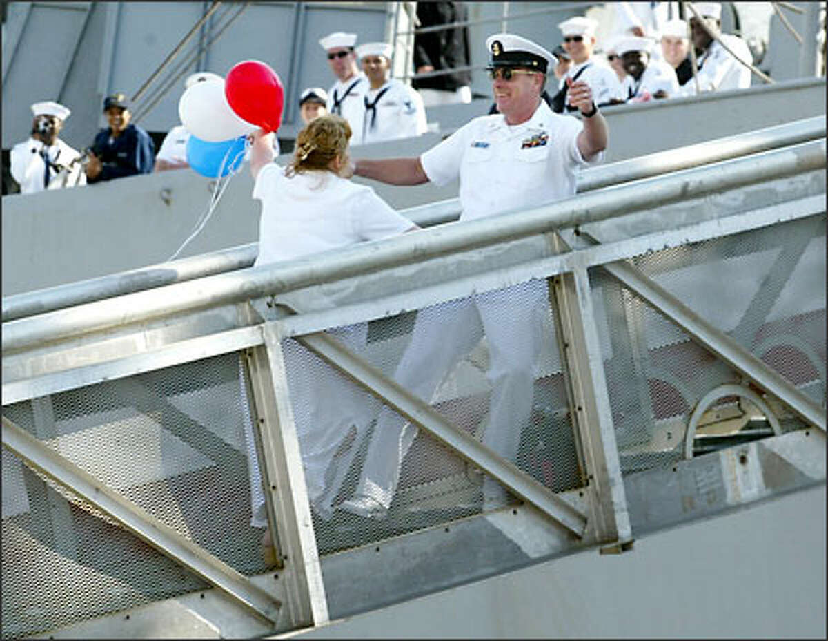 Fire Control Master Chief Danny Mercer, a 20-year Navy veteran, won the lottery to be first off the USS Camden -- and the first to get a kiss. He and his wife, Debbie, rewarded the crowd with a long smooch. Said Debbie Mercer afterward, "Awesome, just like I remember."