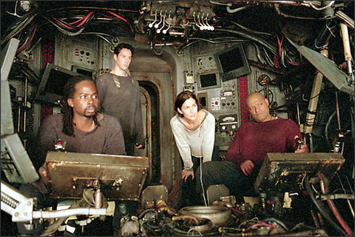 Aboard the Nebuchadnezzar: (l-r) Link (Harold Perrineau), (Keanu Reeves), Trinity (Carrie-Anne Moss) and Morpheus (Laurence Fishburne).
