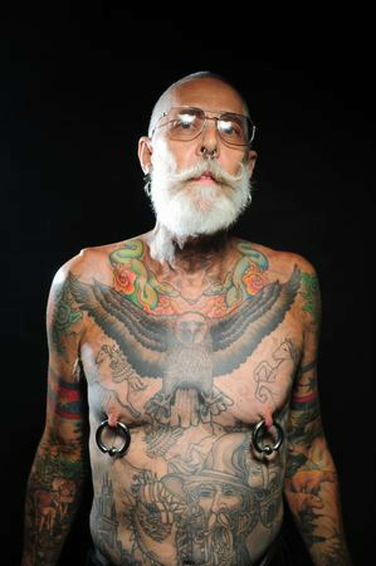 Dan Adcock poses for a portrait during day 1 of the Seattle Tattoo Expo at Seattle Center Friday August 7, 2009. The expo continues until Sunday evening. Photo by Daniel Berman/SeattlePI.com