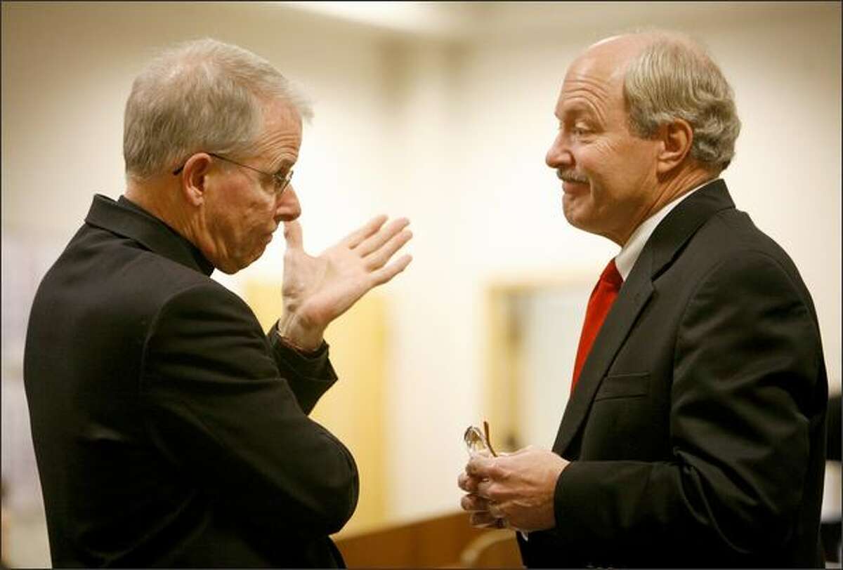 Rev. Michael G. Ryan of Saint James Cathedral confers with defense attorney Michael Patterson during a court proceeding in a lawsuit against the Seattle Archdiocese over child sex abuse by a priest in the 1970s. Two men are seeking unspecified damages from the archdiocese for abuse by a former Spokane priest, Patrick O'Donnell.