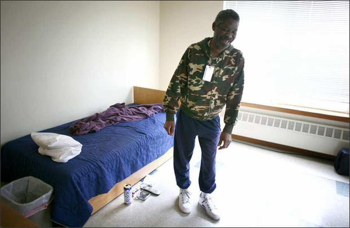 Nathaniel Porter, one of the residents of 1811 Eastlake, a home for people with chronic alcohol addiction, shows off his living quarters on Tuesday.