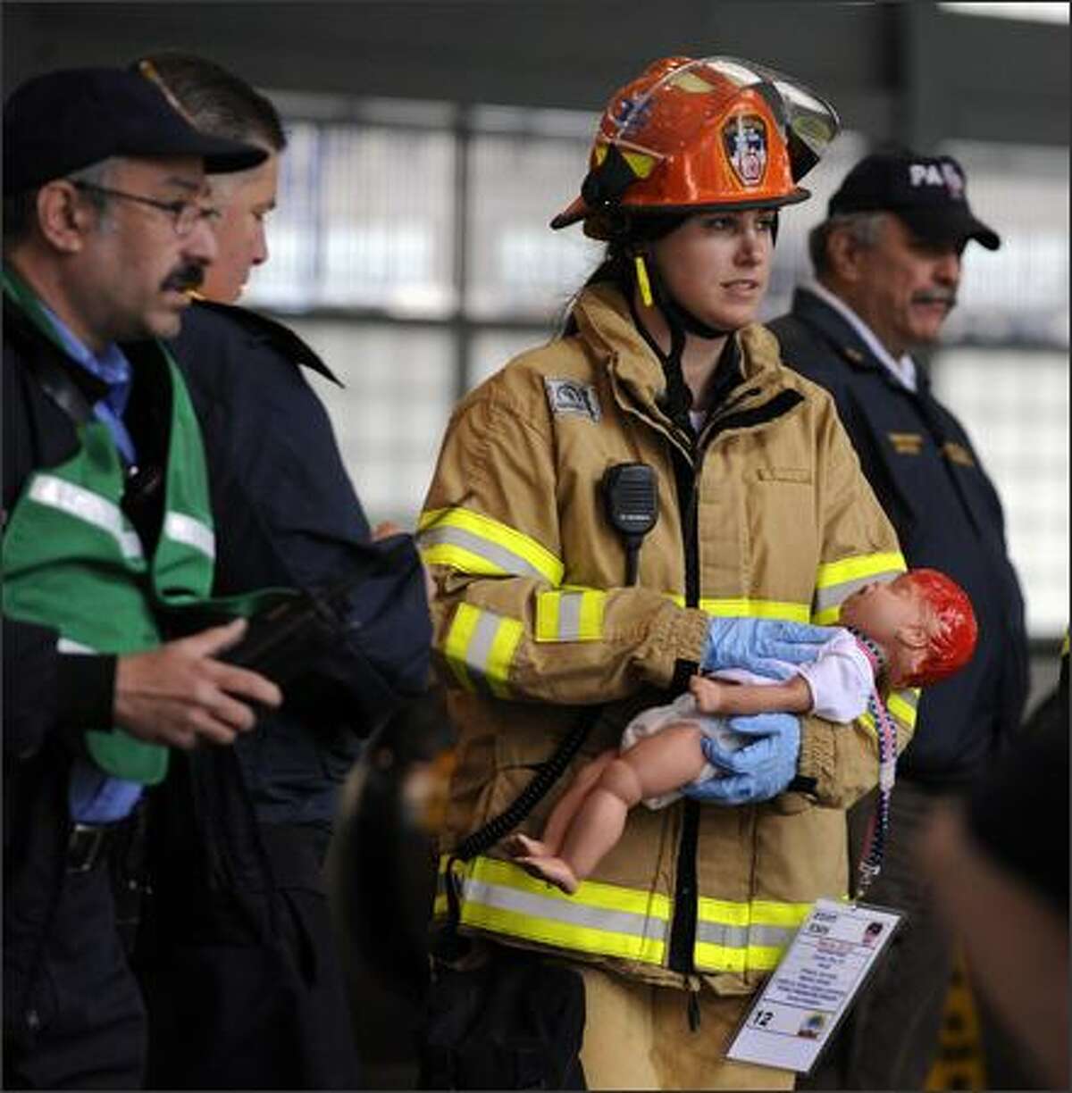 A New York City Fire Department EMS worker carries a dummy baby victim during Operation Safe PATH 2009 Sunday at the PATH station at the World Trade Center. Hundreds of firefighters and police swarmed Ground Zero Sunday, the site where the World Trade Center once stood, in the largest security exercise here since the Sept. 11, 2001 attacks. As part of an elaborate dress rehearsal for a possible future terror strike, rescue workers exploded simulated bombs in a commuter train tunnel linking Manhattan to New Jersey burrowed beneath the Hudson River.