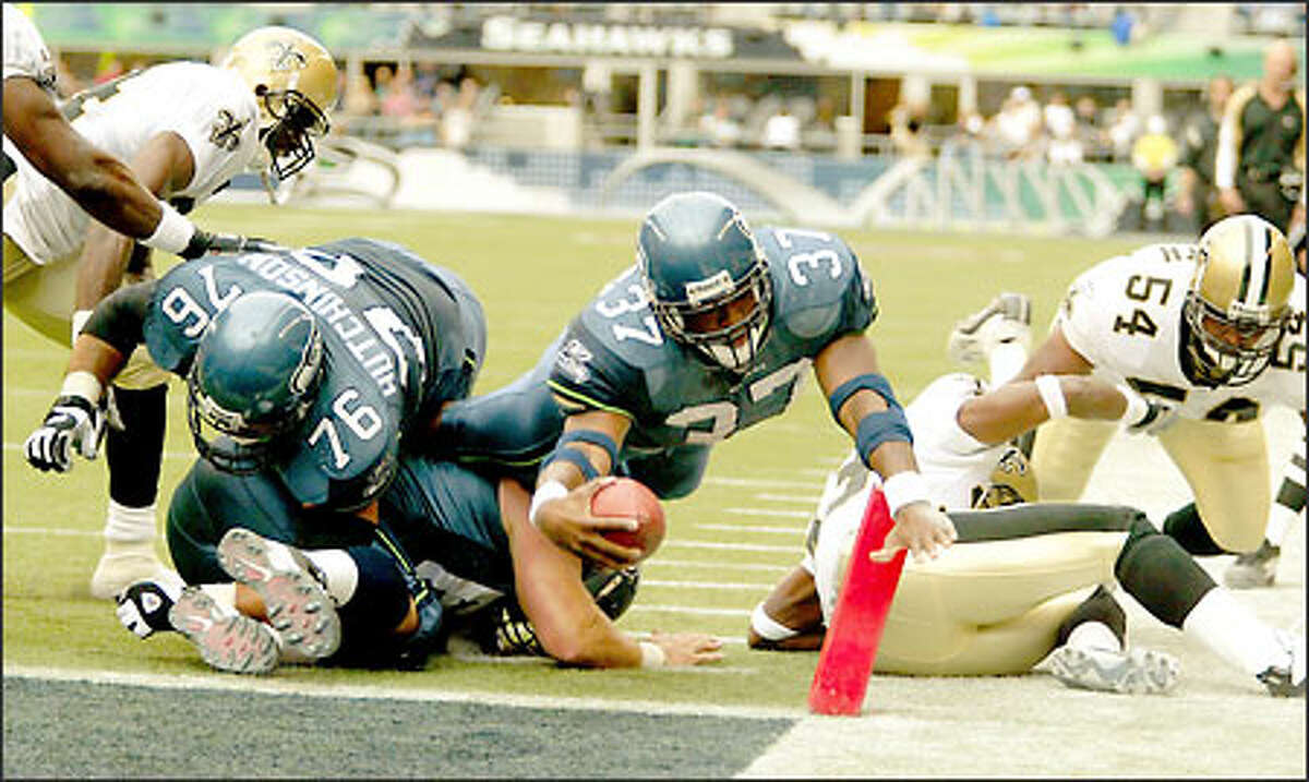 Shaun Alexander, center, dives into the end zone against the Saints after hauling in a 10-yard pass from Matt Hasselbeck with 24 seconds remaining in the second quarter of Seattle's 27-10 victory.