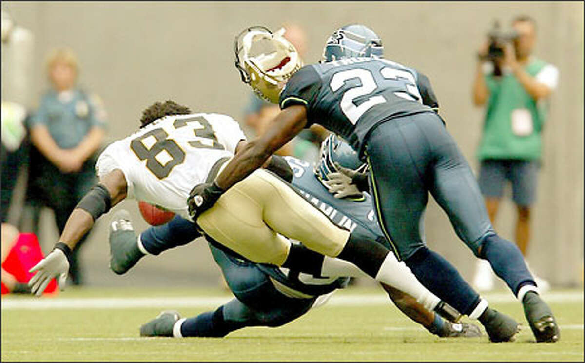 Seahawks rookie Ken Hamlin delivers the crunching hit that knocked the helmet off Saints wideout Donte' Stallworth, with fellow rookie Marcus Trufant close behind.