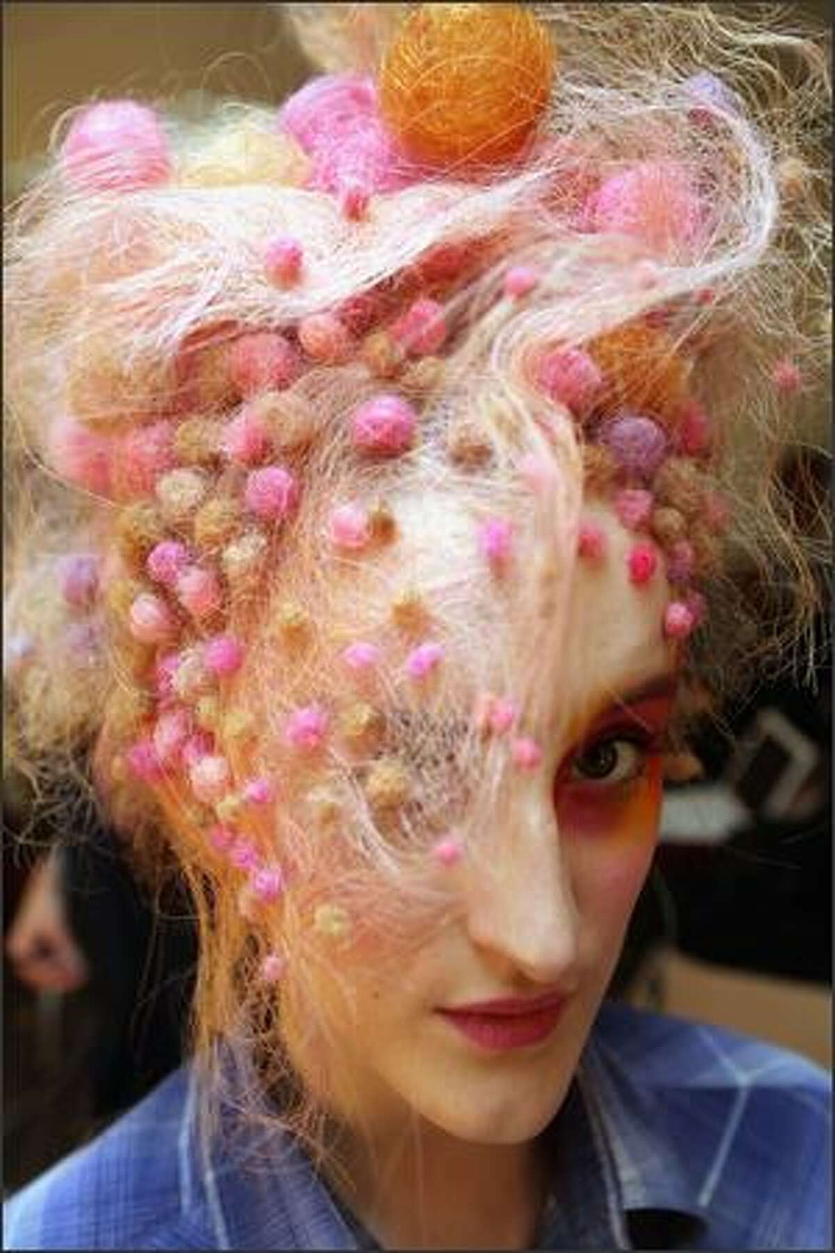 Models prepare in the dressing rooms before taking part in a catwalk show as part of the L'Oreal Colour Trophy Final '09 at Earls Court in London, England.