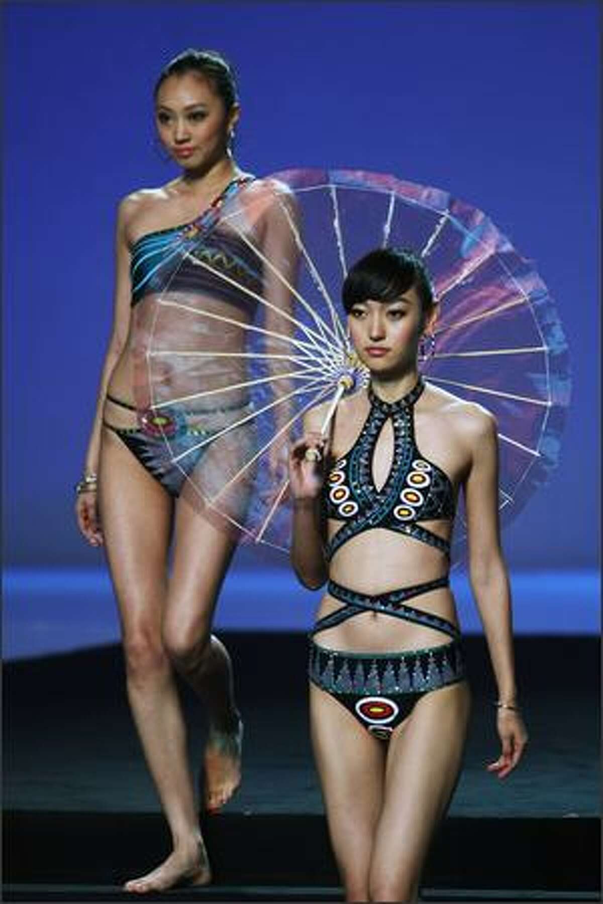 Models pose on the runway during 2009 HOSA CUP, the 6th China Swimming Wear Design Contest at the National Aquatics Center, known as the Water Cube, in Beijing, China.