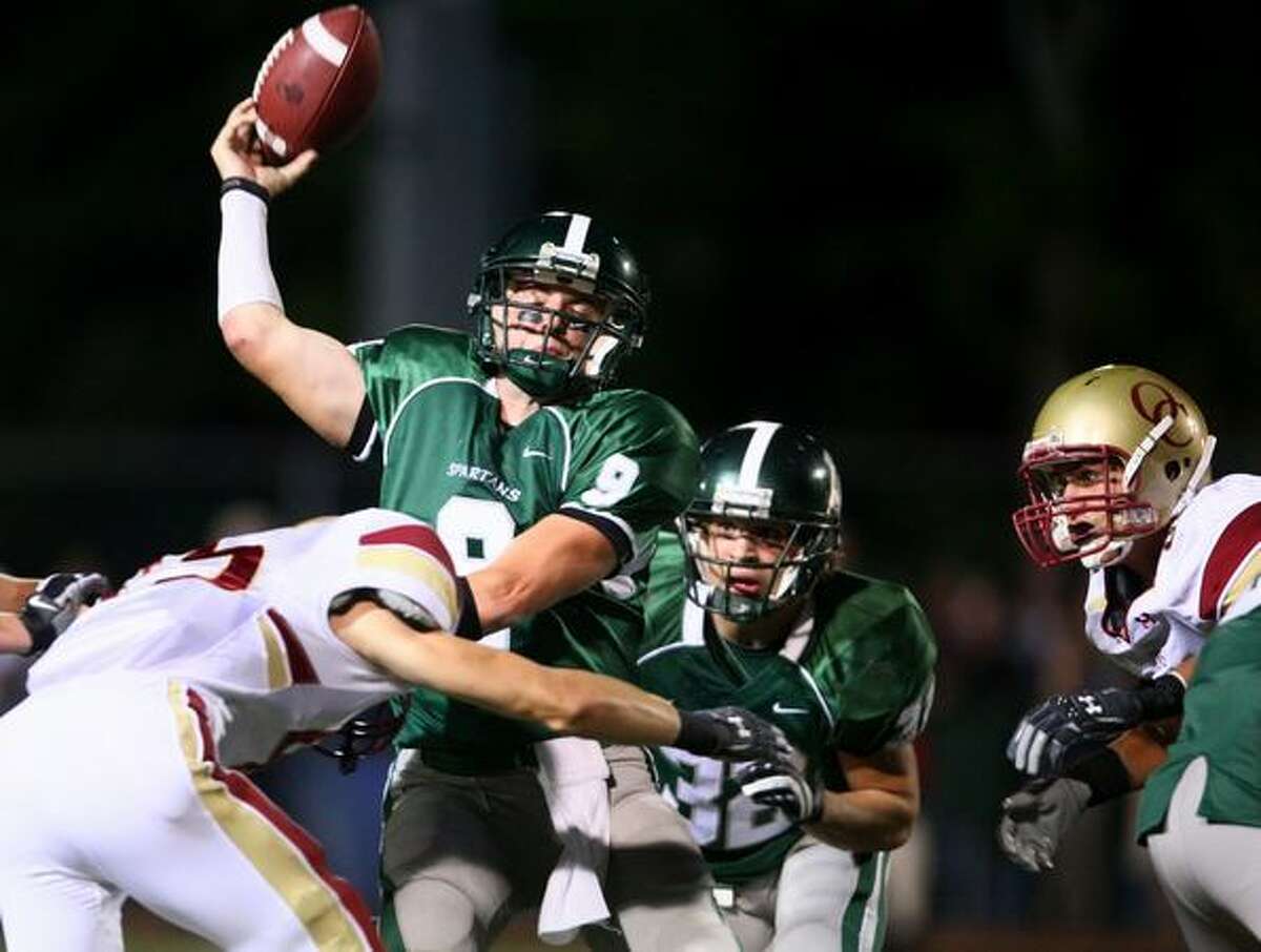 Skyline High School quarterback Jake Heaps is hit by a Oaks Christian player as he loses control of the ball and results in a turnover during Skyline's final possesion of the game.