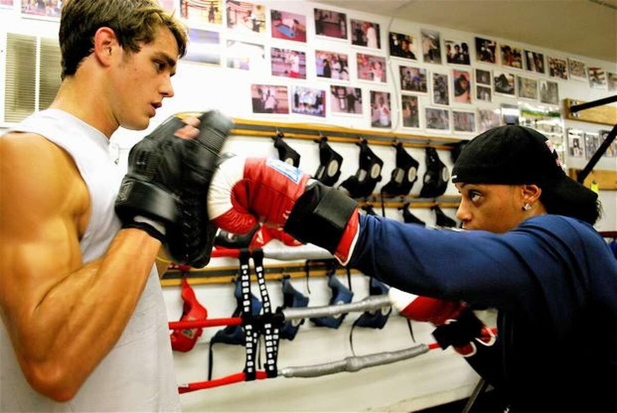 USA boxing champ Queen Underwood works out with Joe Byers, 21, a student at the University of Washington. The two are boxers at Cappy's Boxing Gym on 22nd Ave. and East Union in Seattle.