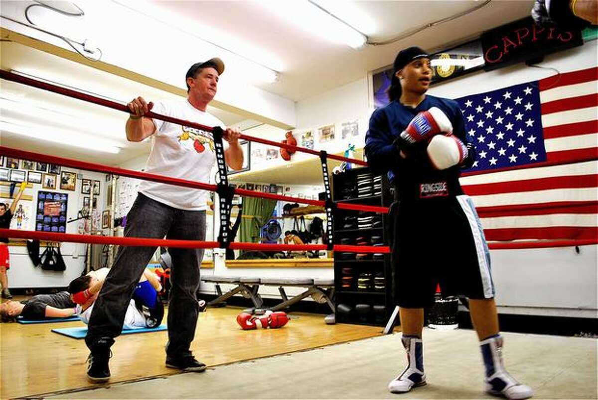 Cap Kotz, Queen Underwood's coach, provides pointers to Underwood during a boxing lesson. Kotz has owned Cappy's Boxing Gym since the mid-1990s. Kotz grew up in Washington and Montana watching his dad box in the Army. He was a boxer, too, before going on to coach.