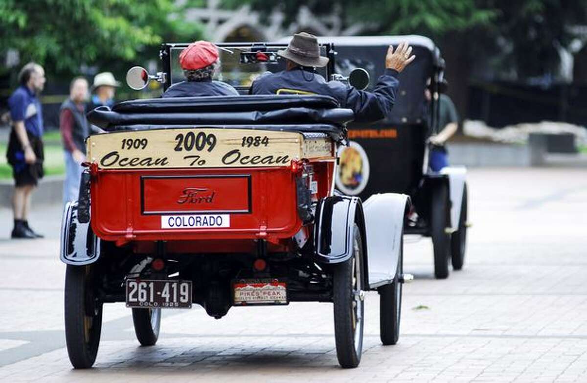 Ford Model T's from the 1909 Ocean to Ocean reenactment race make their way onto the University of Washington campus Sunday.