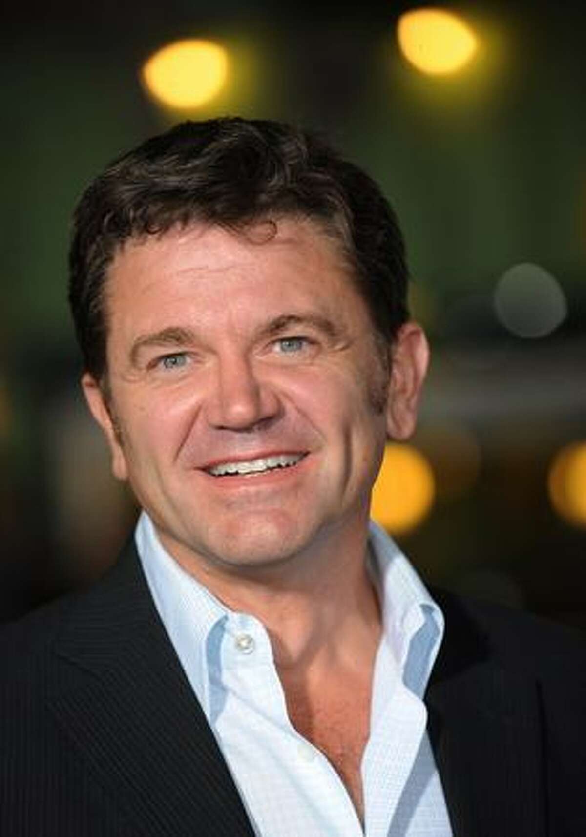 Actor John Michael Higgins poses for photographers as he arrives.